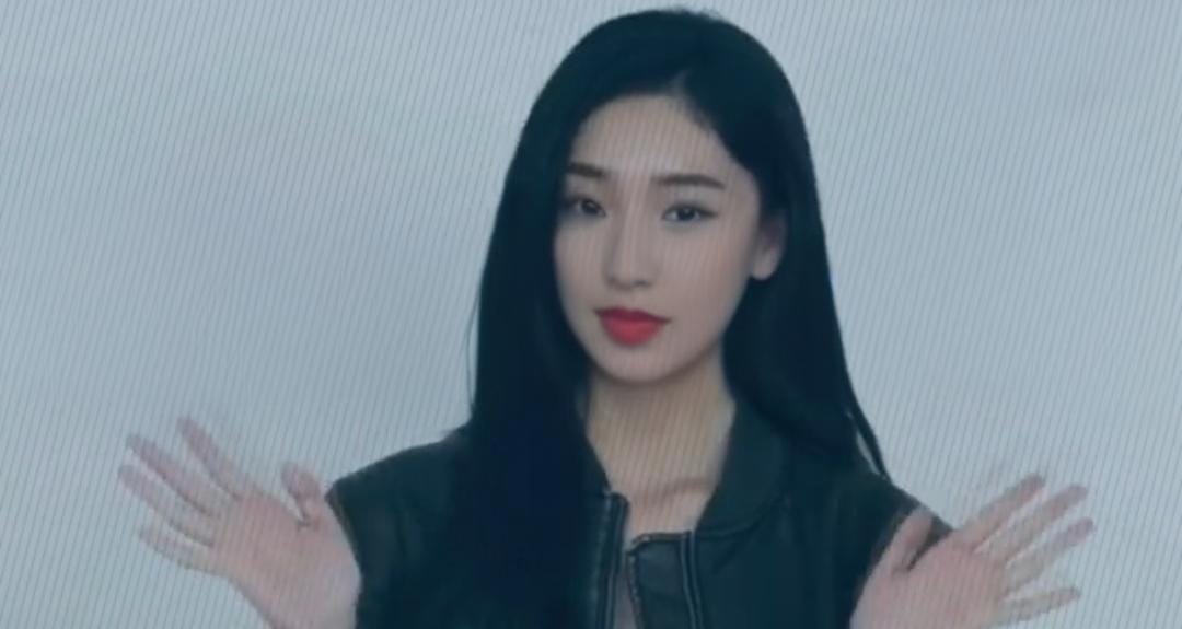 a woman with long black hair and red lipstick